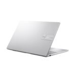 Cool Silver ASUS Vivobook 15 X1504VA-NJ2324WS resting on a wooden table alongside a coffee cup and notebook, depicting a productive work or study environment." (Adjust details like "wooden table" or "coffee cup" based on your specific image)