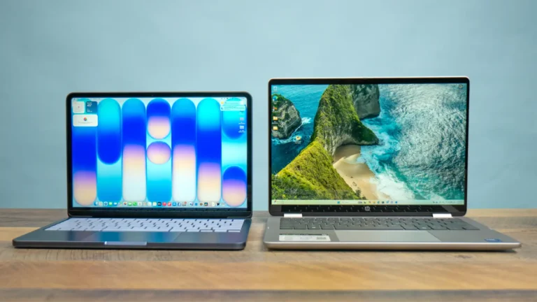 Apple MacBook Pro and HP Pavilion laptop side-by-side on a wooden desk at YourShoppy.com in Koramangala, Bangalore.