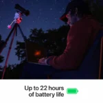 Man uses Apple MacBook Pro 16-inch M5 Max with telescope under starry sky.