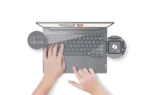 Lenovo ThinkBook 14 G8 IAL-21SJA0LAIG laptop with hands typing on keyboard and icons.