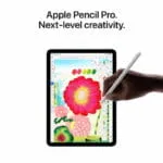 Hand using an Apple Pencil Pro to draw a vibrant flower on an Apple iPad Air 13-inch M4 tablet at YourShoppy.com.