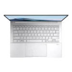 Top-down view of the Foggy Silver ASUS Zenbook 14 OLED UX3405CA-QL1507WS laptop with a backlit keyboard and NumberPad.