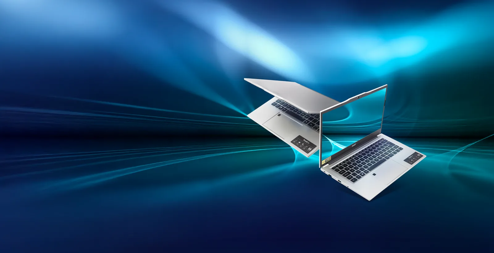 Two Acer TravelLite business laptops in silver