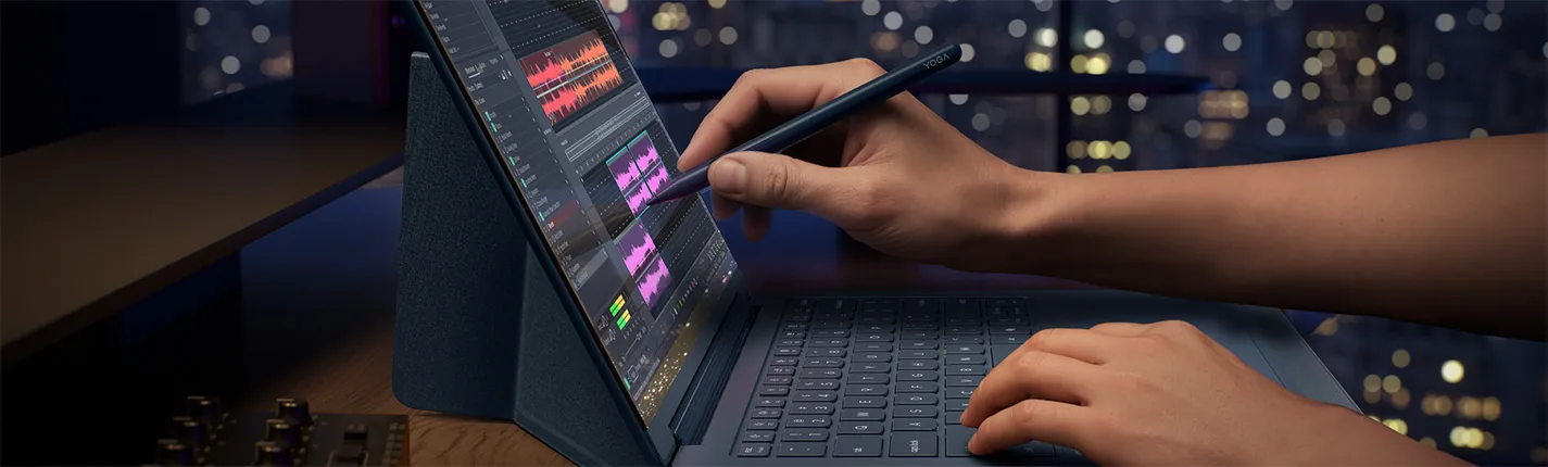 Hands drawing with a pen on a Lenovo Yoga laptop