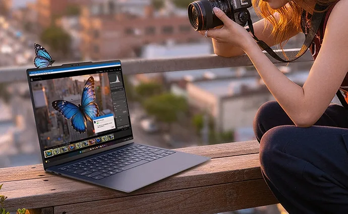Photographer editing on a Lenovo Yoga Slim laptop